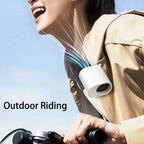 Hipacool portable clip fan attached to jacket of woman riding a bicycle.